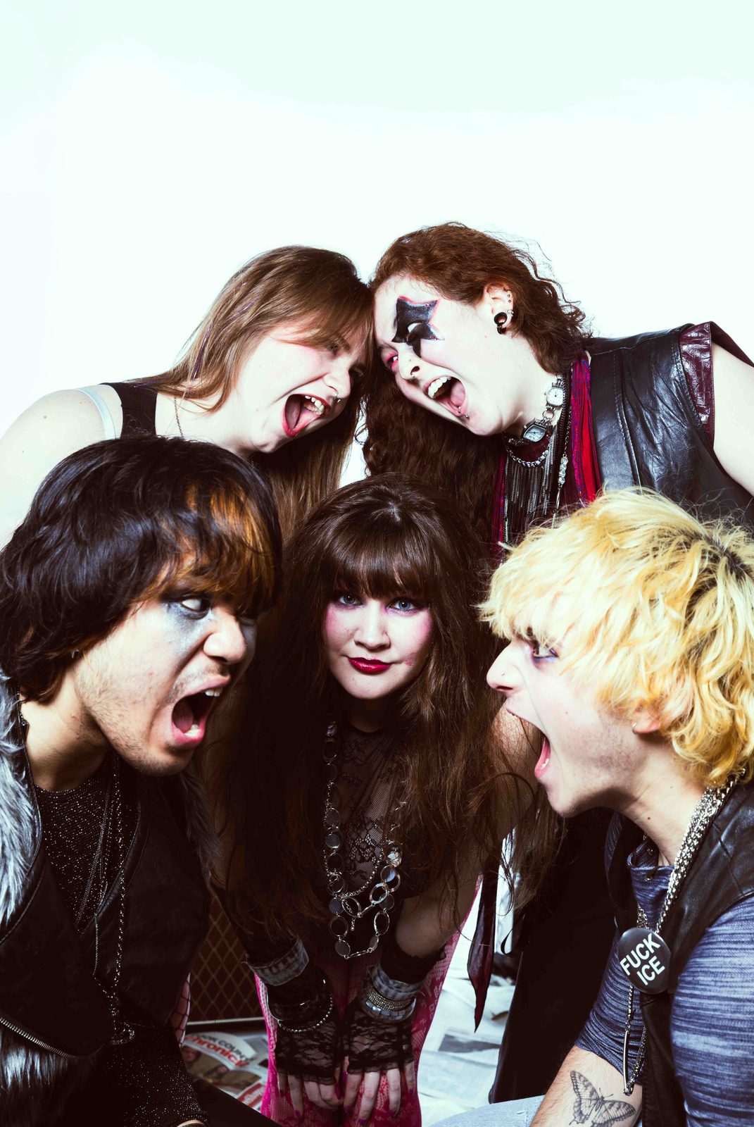 RED STATE: the four band members pressed together, screaming toward the camera